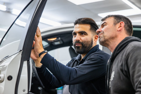 Window tint student receiving live installation coaching